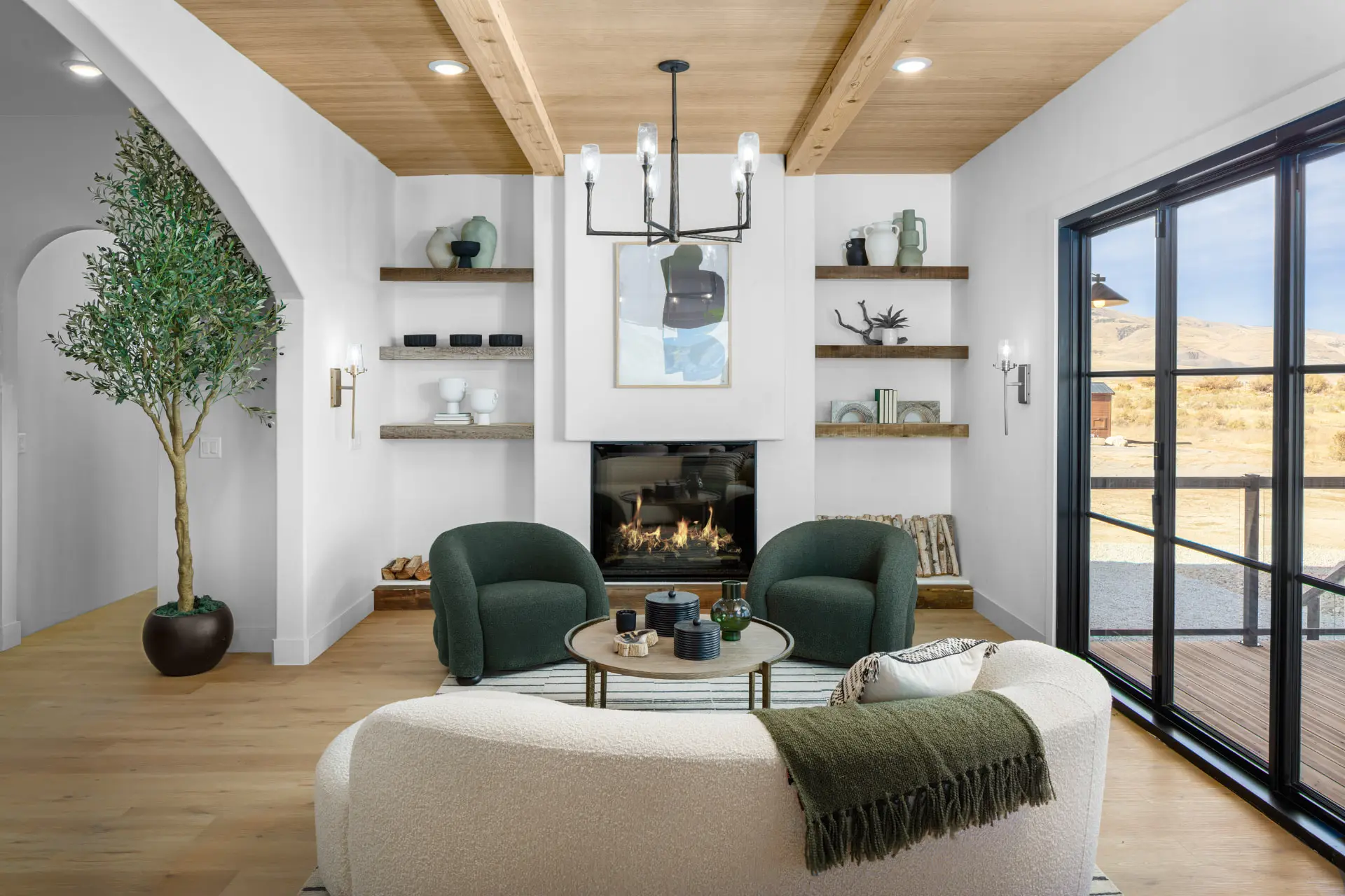 Iron chandelier and vanity-style sconces in a Tooele, Utah hearth room