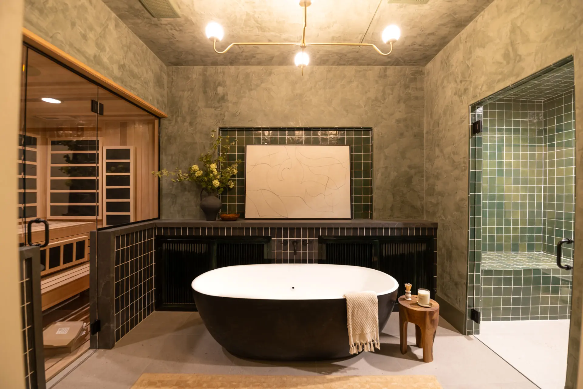Spa bath with a brass globe chandelier, sauna, and steam shower