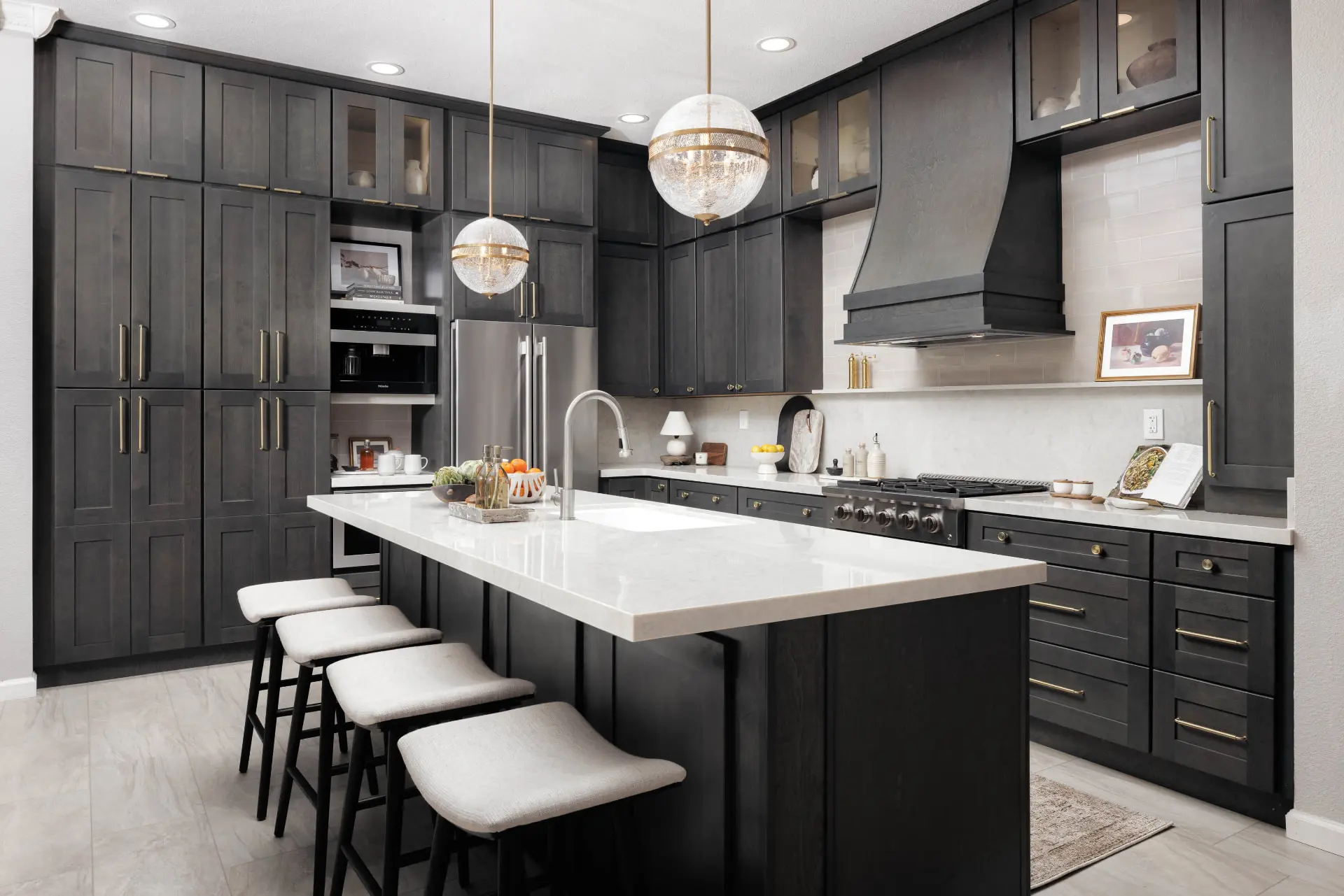 Charcoal shaker kitchen with two crackled glass globe pendants above a white marble island