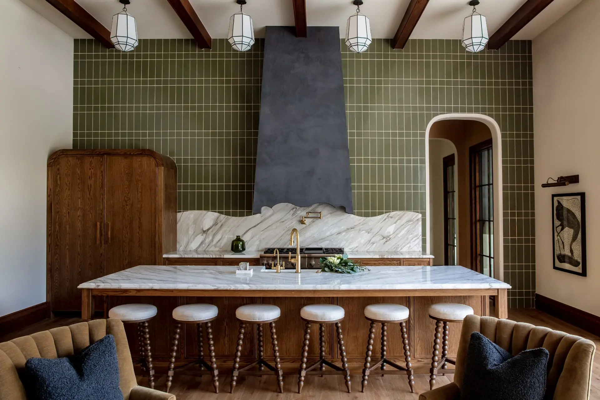 Four white lanterns above a marble island against a green tile range wall